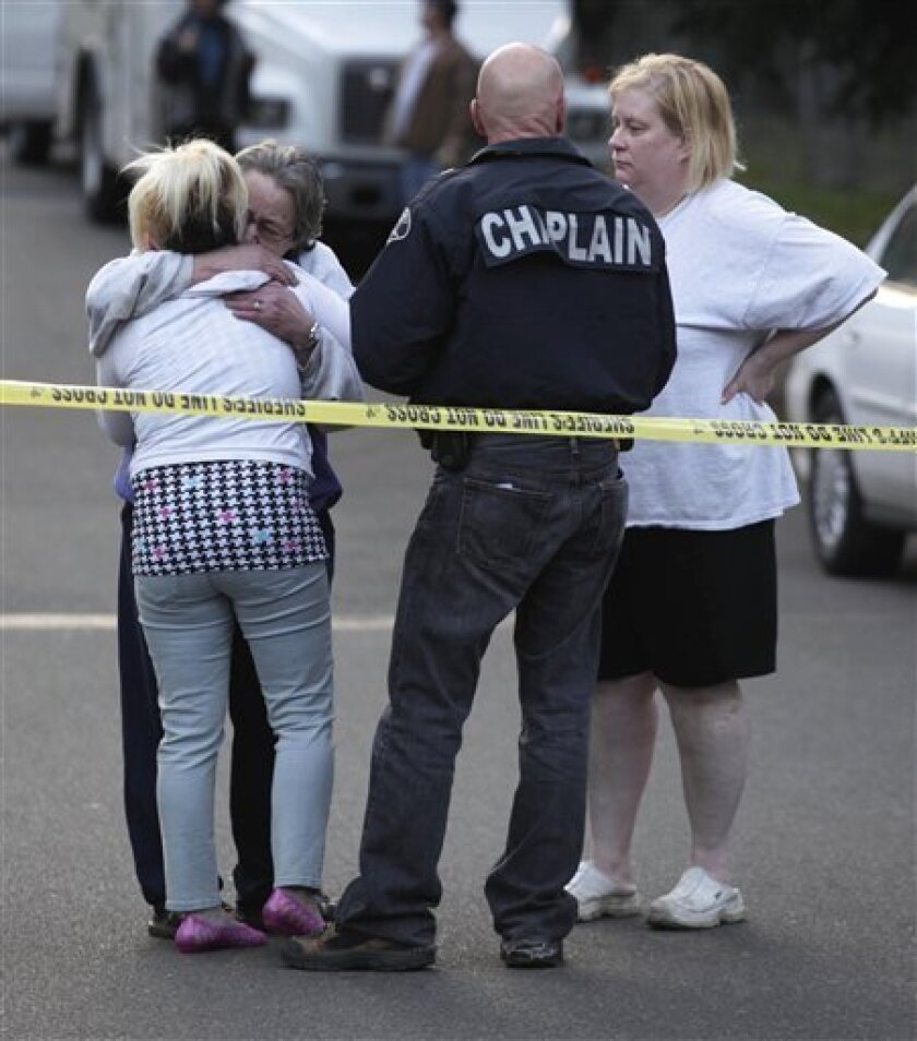 * A Pierce Co. Sheriffs Chaplain Rick Bulman talks with three unidentified women Saturday, April 4, 2009, at trailer park near near Graham, Wash., where the bodies of five children were discovered dead in their home Saturday afternoon. (AP Photo/Ted S. Warren)