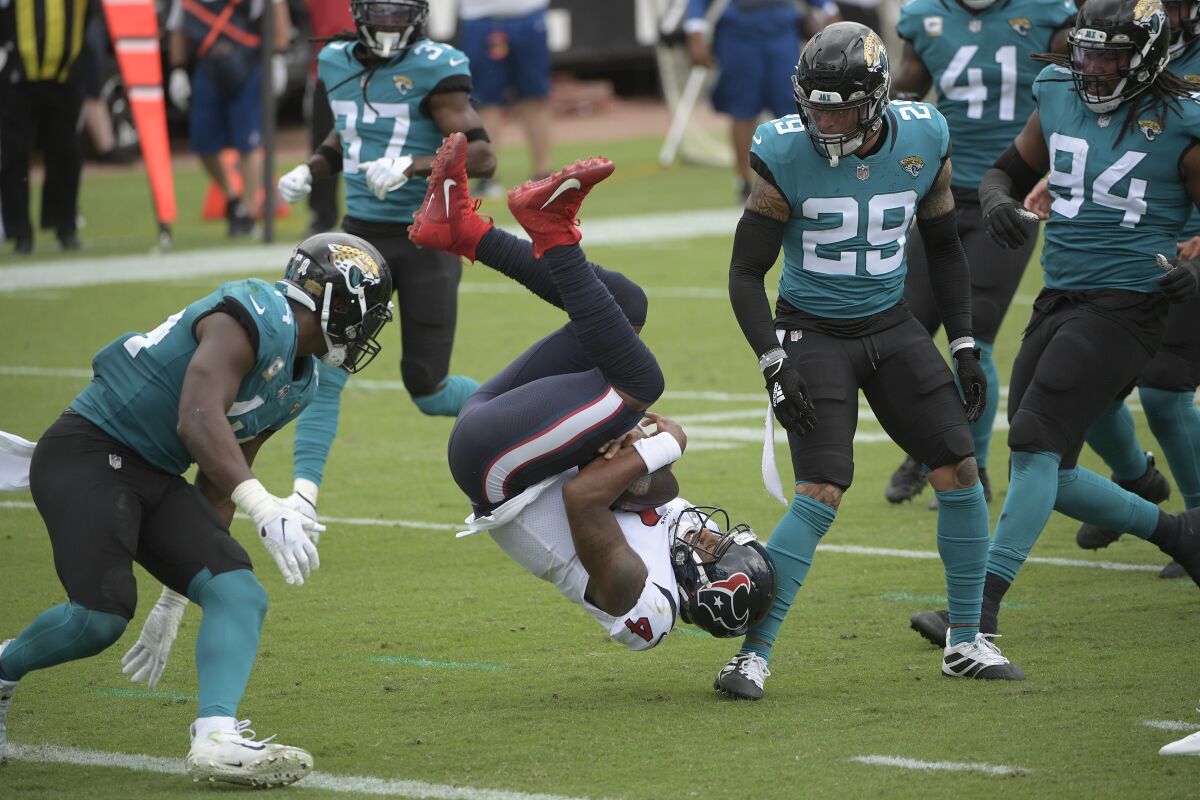 Houston Texans quarterback Deshaun Watson is upended by Jacksonville Jaguars safety Josh Jones.