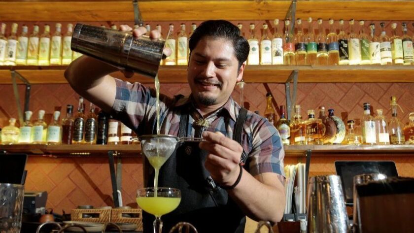 Madre bartender Bryant Orozco mixes a mezcal cocktail