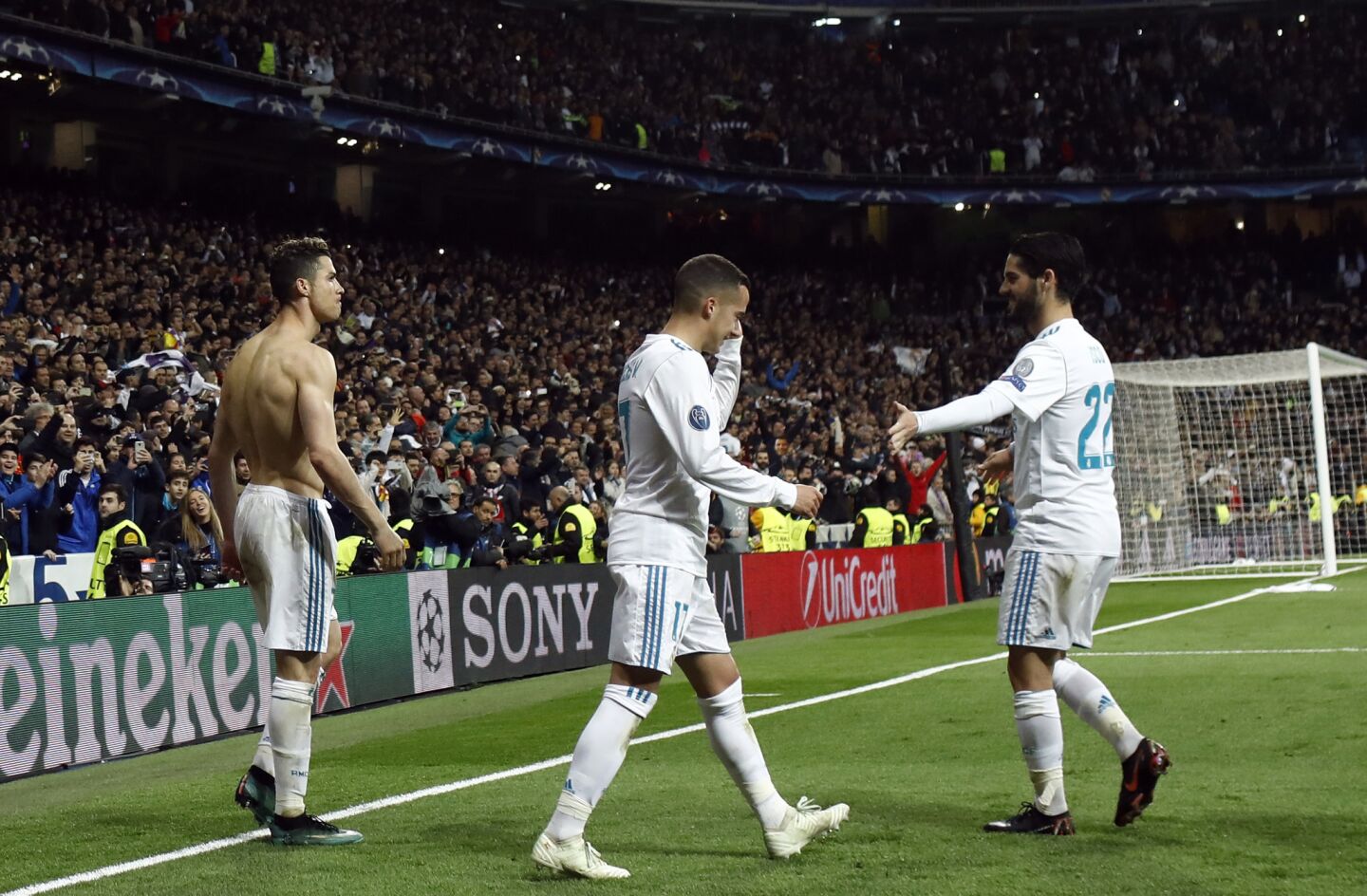 Real Madrid's Portuguese forward Cristiano Ronaldo (L) celebrates with Real Madrid's Spanish midfielder Lucas Vazquez and Real Madrid's Spanish midfielder Isco after scoring during the UEFA Champions League quarter-final second leg football match between Real Madrid CF and Juventus FC at the Santiago Bernabeu stadium in Madrid on April 11, 2018. / AFP PHOTO / OSCAR DEL POZOOSCAR DEL POZO/AFP/Getty Images ** OUTS - ELSENT, FPG, CM - OUTS * NM, PH, VA if sourced by CT, LA or MoD **