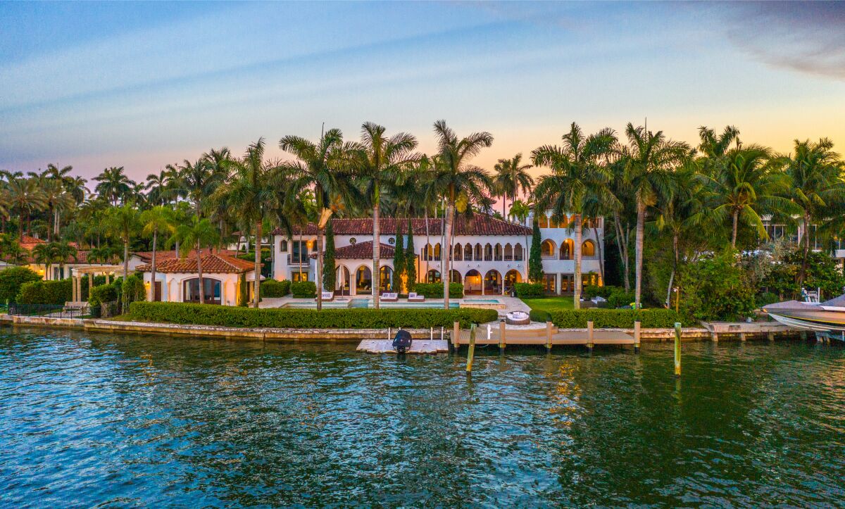 The three-story mansion spans 11,460 square feet and boasts 158 feet of water frontage.