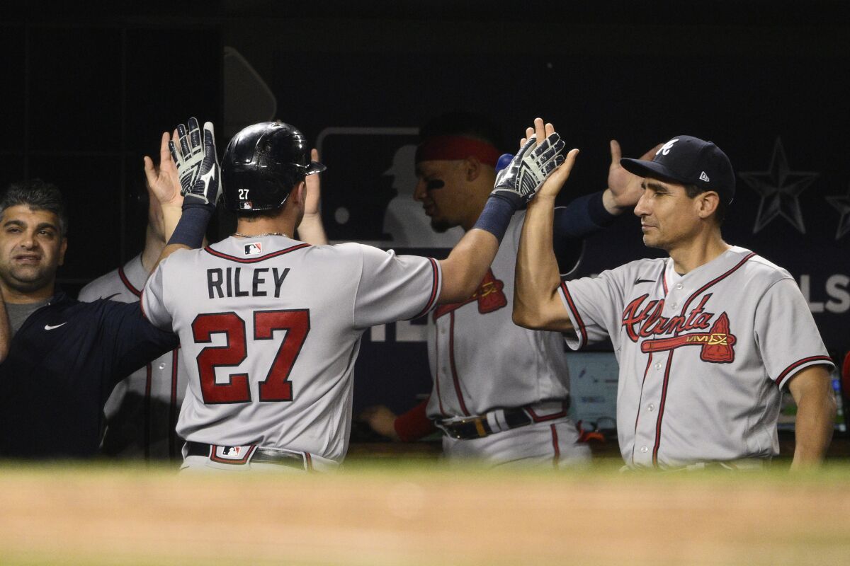 Atlanta Braves' Austin Riley is congratulated for his two-run home run against the Washington Nationals during the seventh inning of a baseball game Wednesday, June 15, 2022, in Washington. The Braves won 8-2. (AP Photo/Nick Wass)
