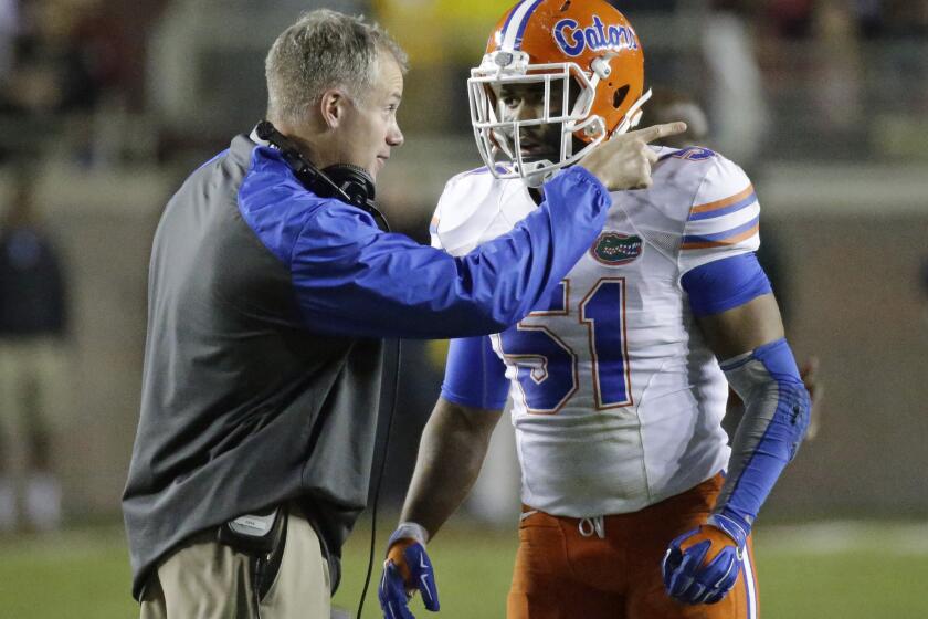 D.J. Durkin talks with linebacker Michael Taylor during Florida's game against Florida State last season.