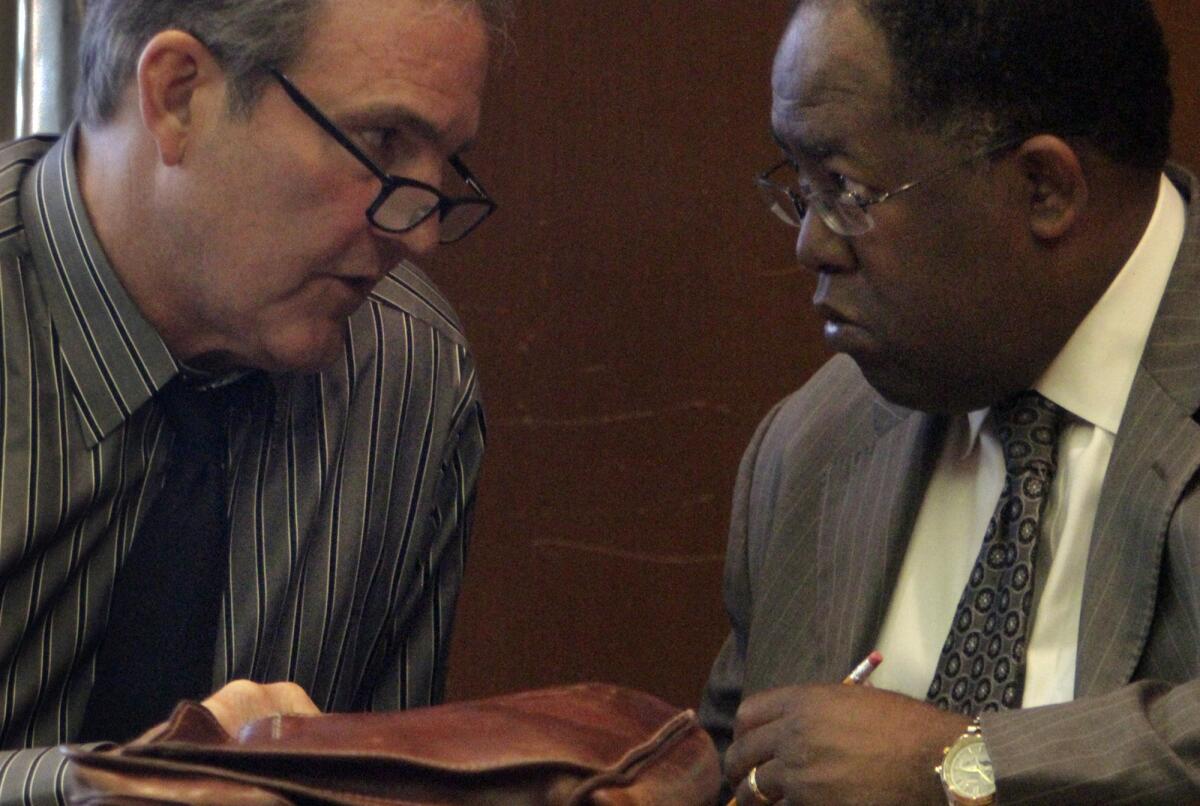 Coliseum commissioners Bill Chadwick and Mark Ridley-Thomas confer at a Los Angeles Memorial Coliseum Commission meeting in 2011.
