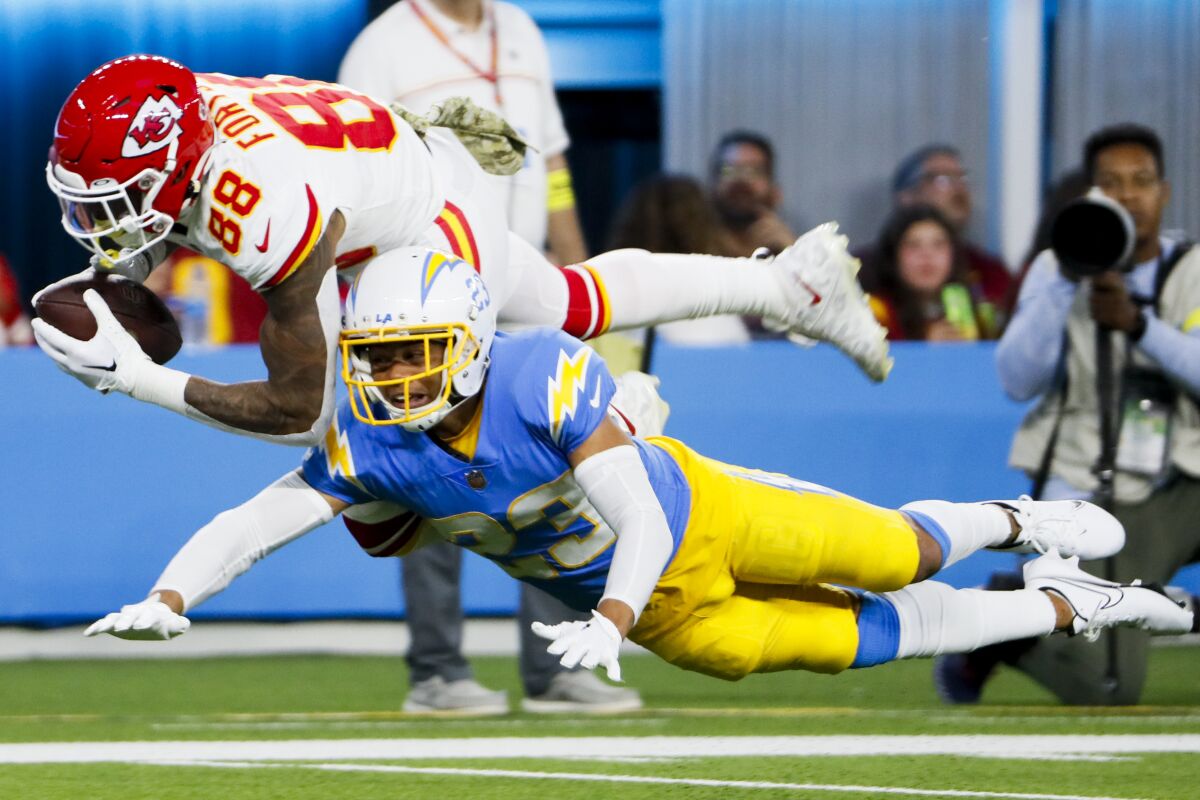Chiefs tight end Jody Fortson falls to the ground after a catch while Chargers cornerback Bryce Callahan falls next to him