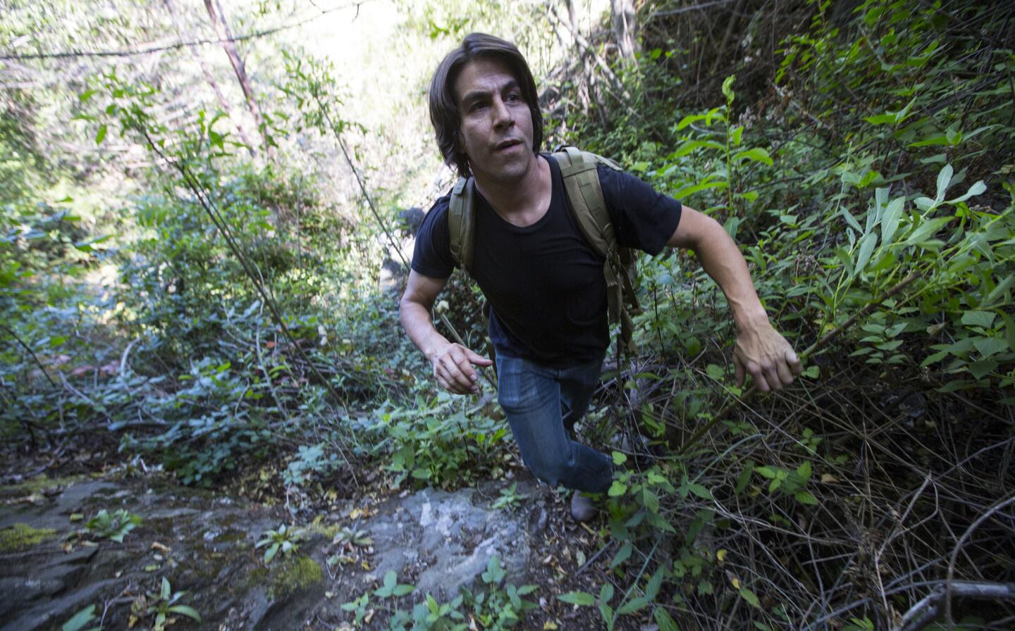 Camera trapper Robert Martinez hikes into the Angeles National Forest from Glendora to check his cameras.