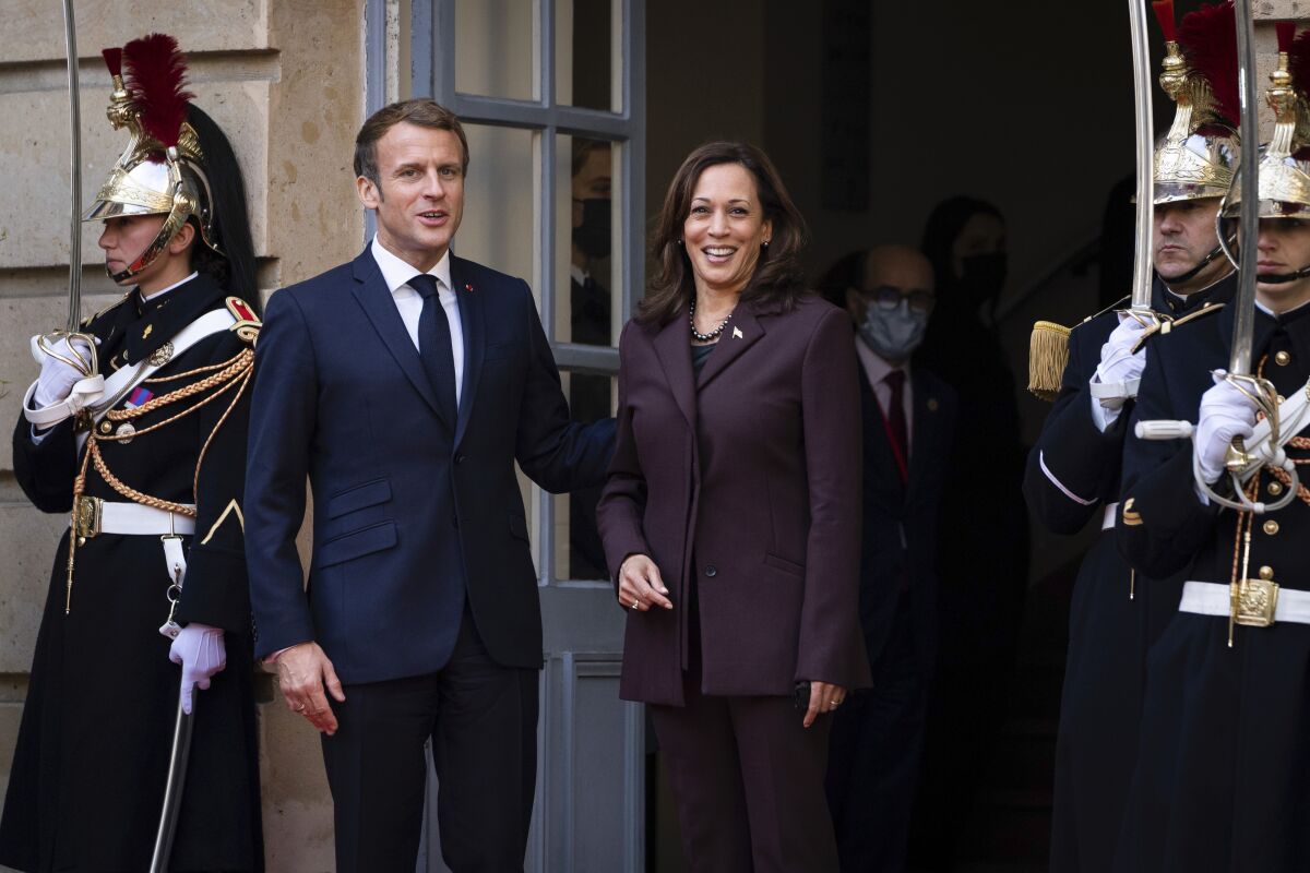 French President Emmanuel Macron, left, welcomes Vice President Kamala Harris to the Paris Conference on Libya in Paris, Friday, Nov. 12, 2021. (Sarahbeth Maney/The New York Times via AP, Pool)