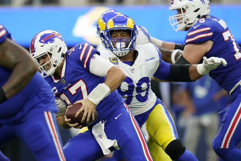 Buffalo Bills quarterback Josh Allen (17) is sacked by Los Angeles Rams defensive tackle Aaron Donald (99) during the first half of an NFL football game Thursday, Sept. 8, 2022, in Inglewood, Calif. (AP Photo/Ashley Landis)