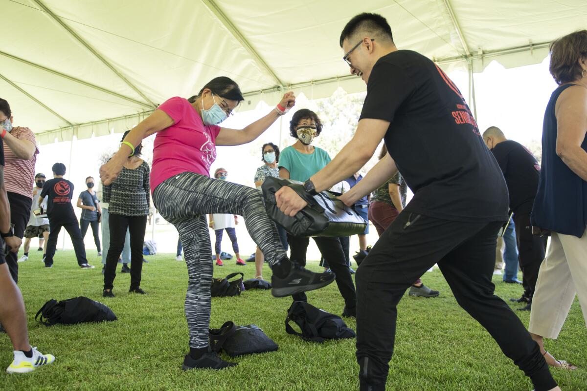 Wan Palachan practices her kicking skills during a self-defense workshop at Don Knabe Community Regional Park in Cerritos.  