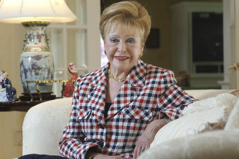 FILE - In this June 3, 2004 file photograph, author Mary Higgins Clark poses in her home in Saddle River, N.J. Clark, the tireless and long-reigning "Queen of Suspense" whose tales of women beating the odds made her one of the world's most popular writers, died Friday, Jan. 31, 2020, at age 92. Clark's publisher, Simon & Schuster, announced that Clark died in Naples, Fla, of natural causes. (AP Photo/Mike Derer, File)