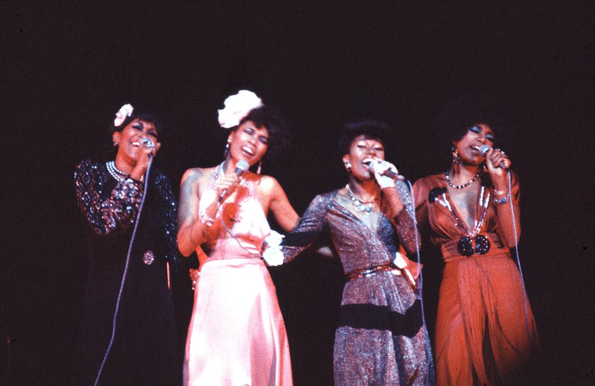 Ruth Pointer, Anita Pointer, Bonnie Pointer and June Pointer perform while wearing gowns of different colors.