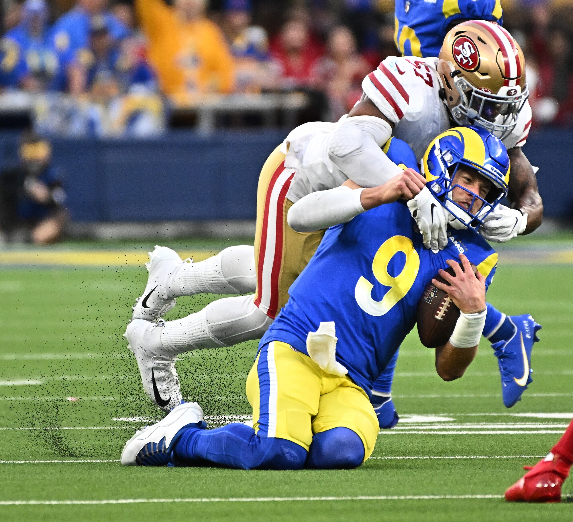 Rams quarterback Matthew Stafford is brought down by 49ers linebacker Dre Greenlaw.
