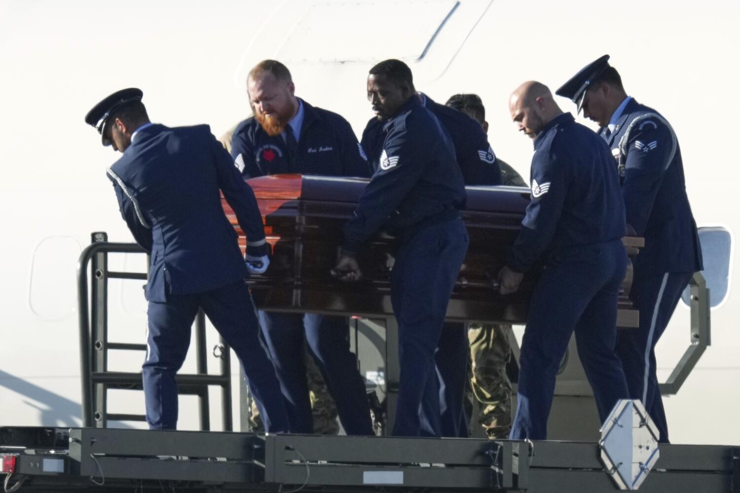 Kirk's casket is carried from the plane in Phoenix.