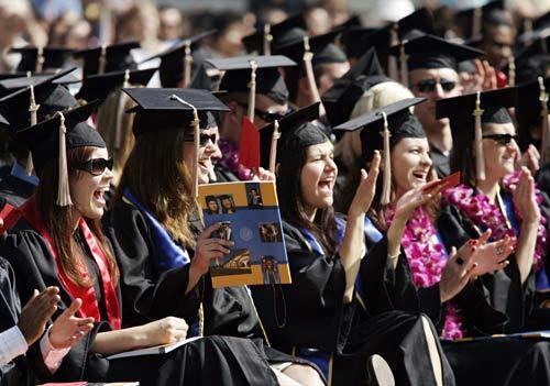 UC Riverside graduates cheer at a delayed commencement ceremony for business administration students. The festivities were postponed from Friday because of a bomb scare. Security was tight; only guests with tickets were allowed to enter the commencement area.