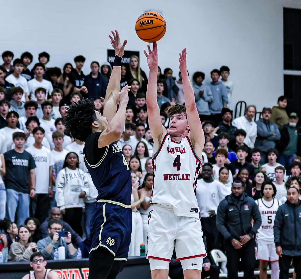 Harvard-Westlake High's Nicolas Khamenia, right, shoots over Notre Dame's Tyran Stokes.