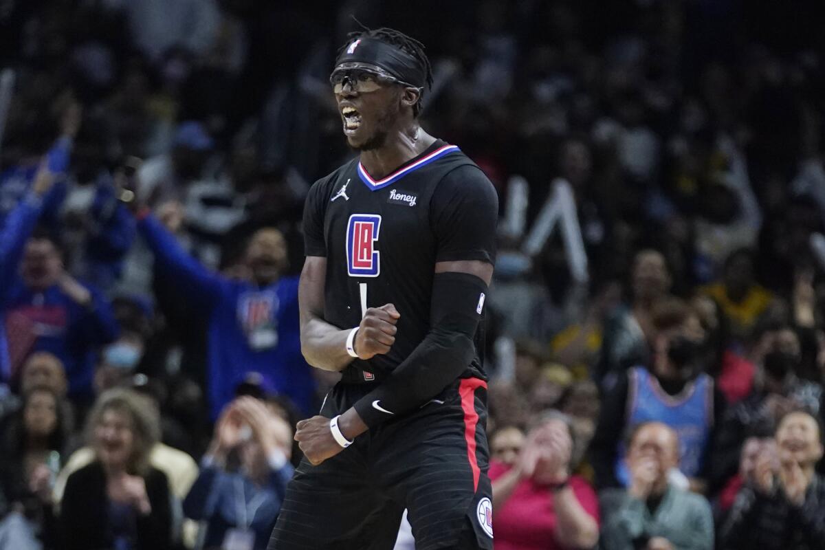 Clippers guard Reggie Jackson reacts after making a 3-point basket during the second half against the Lakers.