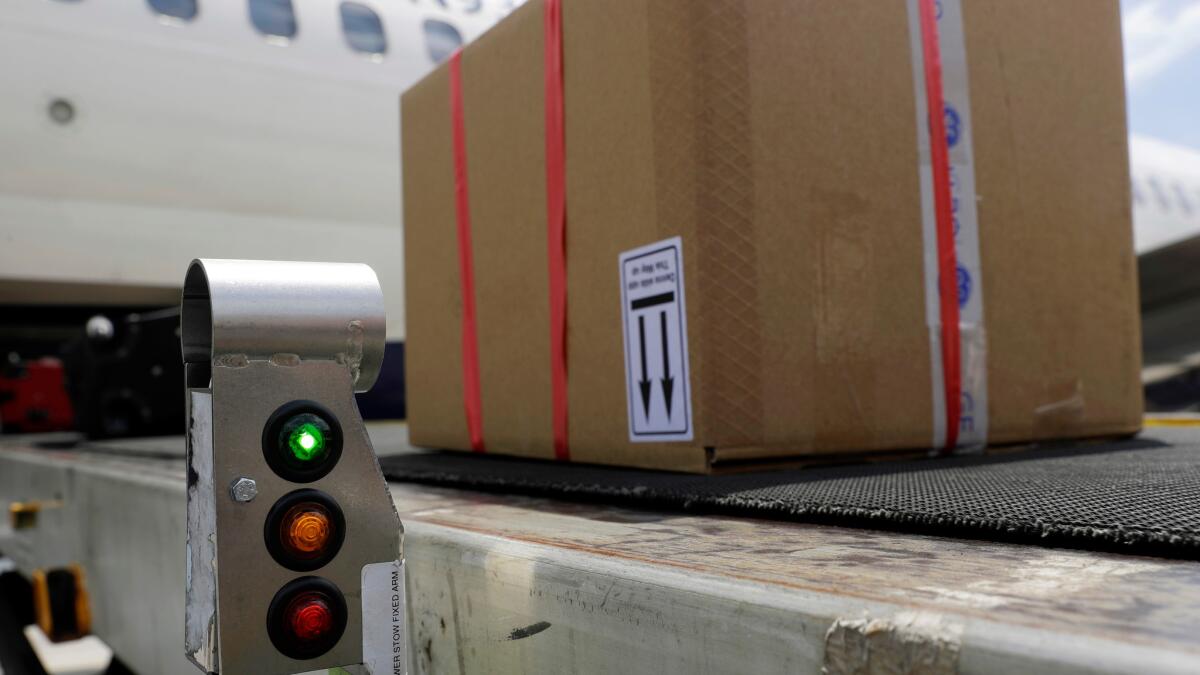 A scanner displays a green light as it detects a tag enabled with radio-frequency identification on a package being loaded onto a Delta flight at Baltimore Washington International Airport.