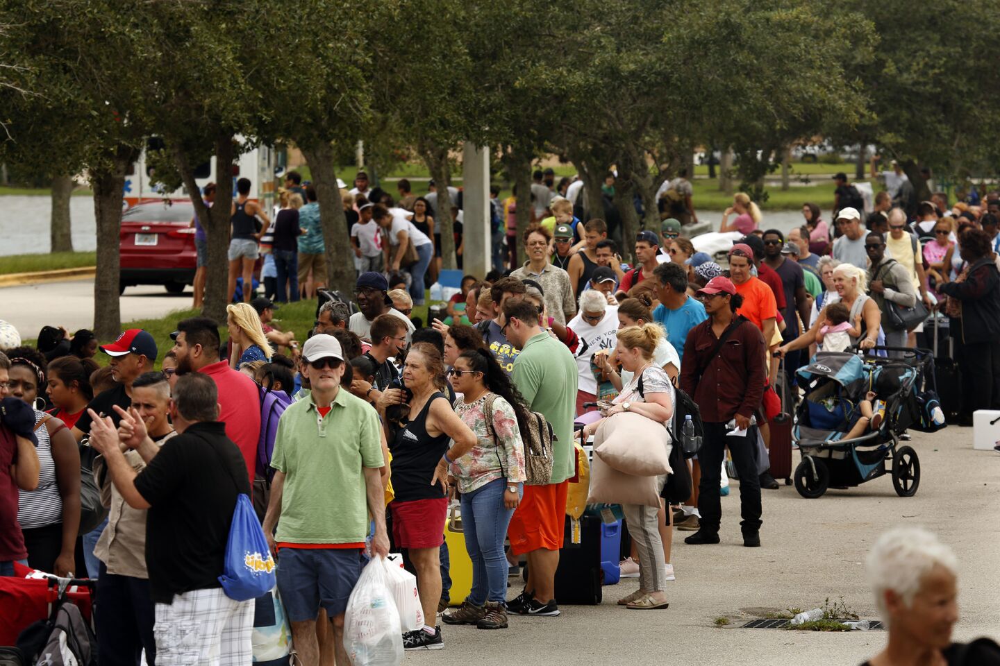 Thousands wait Saturday to enter a storm shelter set up at Germain Arena in Estero, Fla., south of Fort Myers.