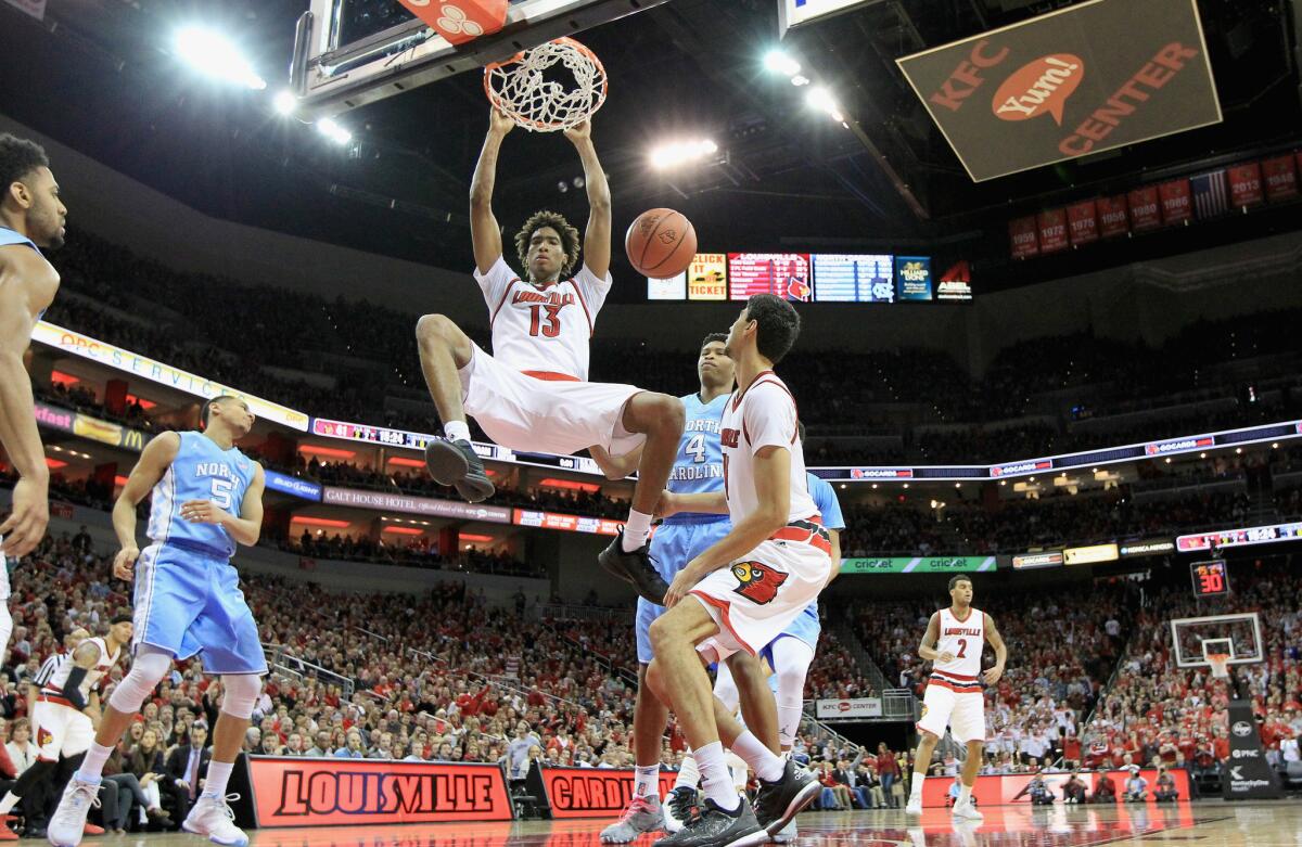 Louisville forward Ray Spalding (13) dunks the ball over North Carolina defenders during the Cardinals' 71-65 win.