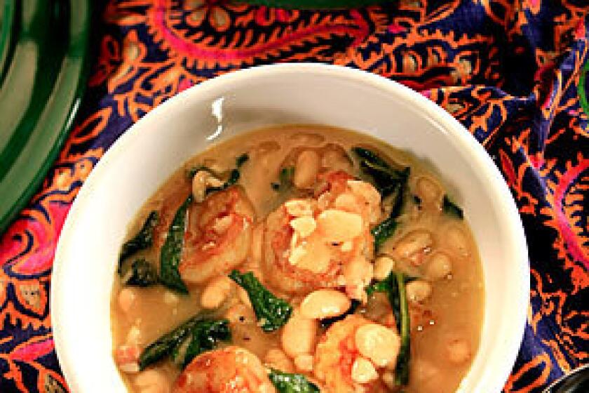HEARTY: White bean and shrimp stew with dandelion greens.