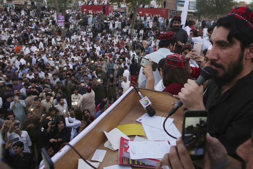 In this Sunday, April 22, 2018 photo, Manzoor Pashteen, a leader of Pashtun Protection Movement addresses his supporters during a rally in Lahore, Pakistan. A Pakistani rights group in the country's troubled border region has been protesting police brutality, censorship and disappearances, drawing a police campaign against its members and deepening tensions. (AP Photo/K.M. Chaudary)
