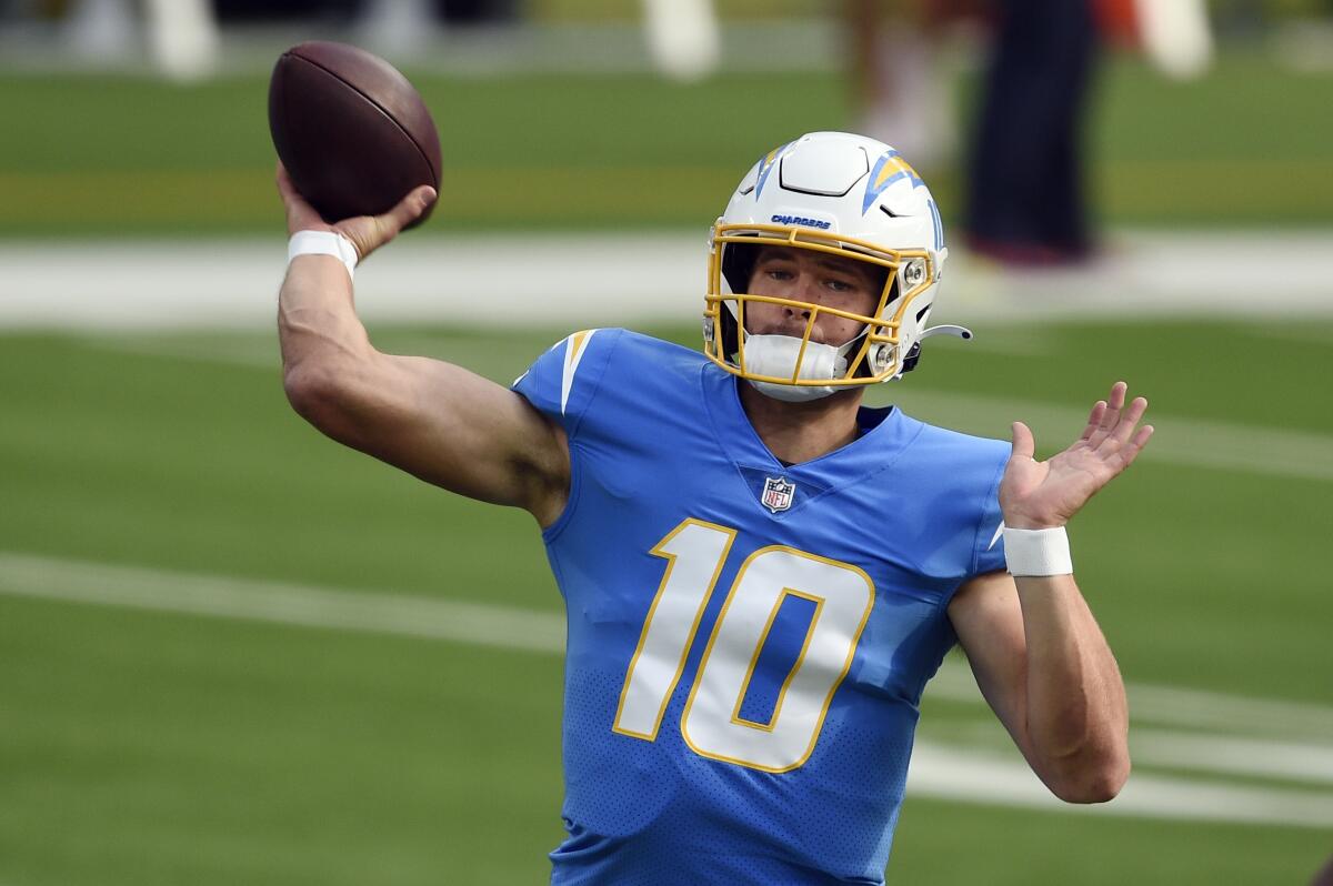 Chargers quarterback Justin Herbert is about to throw a football.