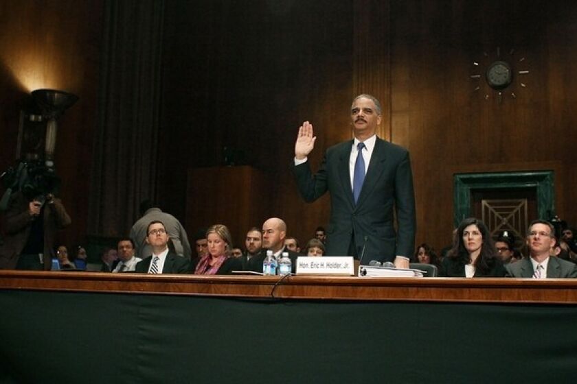 Atty. Gen. Eric H. Holder Jr. is sworn in before testifying during a Senate Judiciary Committee hearing about the controversial "Fast and Furious" gun-running program.