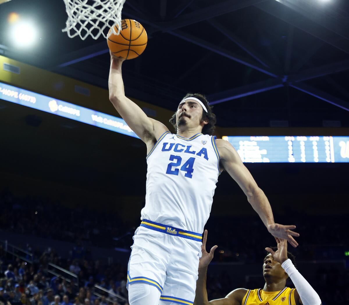 UCLA's Jaime Jaquez Jr. dunks in front of Arizona State's Alonzo Gaffney during the first half Thursday at Pauley Pavilion.