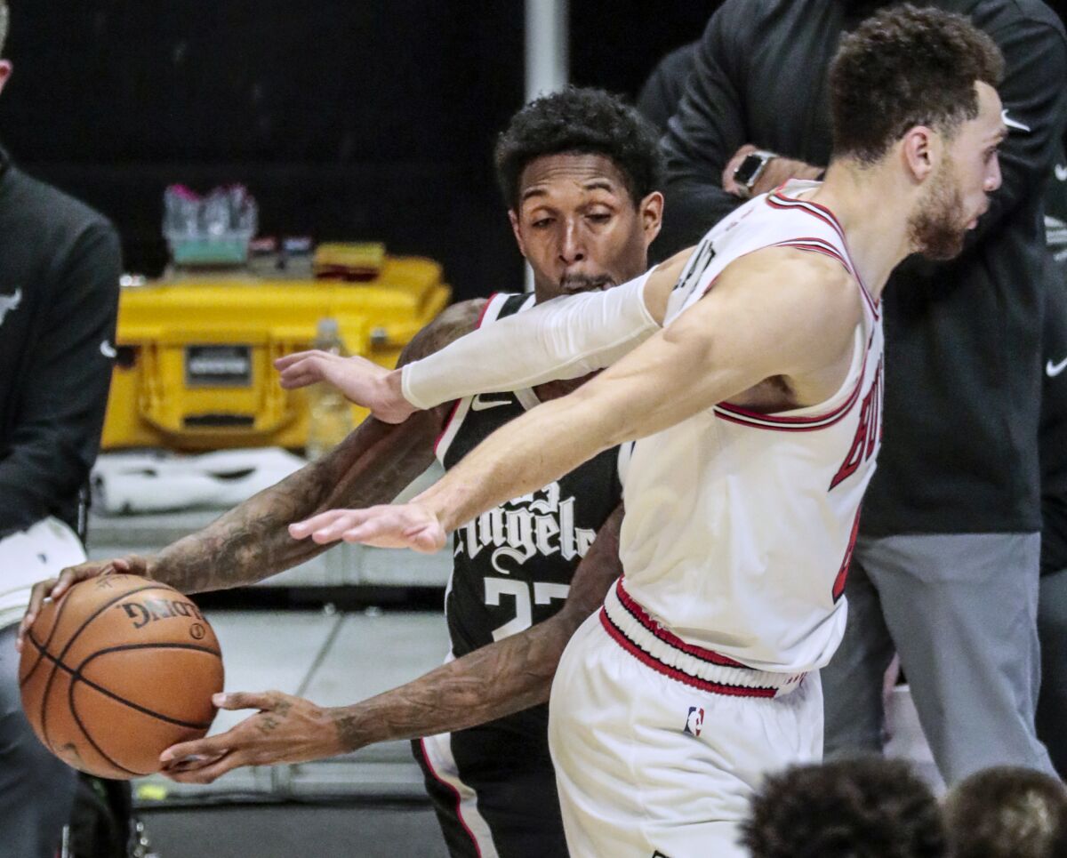 Clippers guard Lou Williams forces Bulls guard Zach LaVine into a foul on Jan. 10, 2020, at Staples Center.