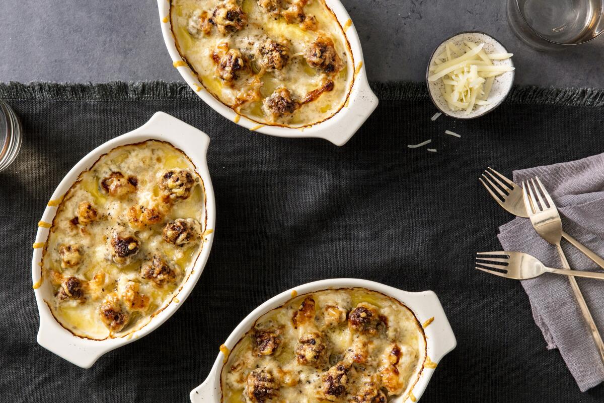 Meatballs flavored with spicy Dijon mustard lift a creamy gratin of cauliflower showered with Gruyere cheese. Prop styling by Kate Parisian.