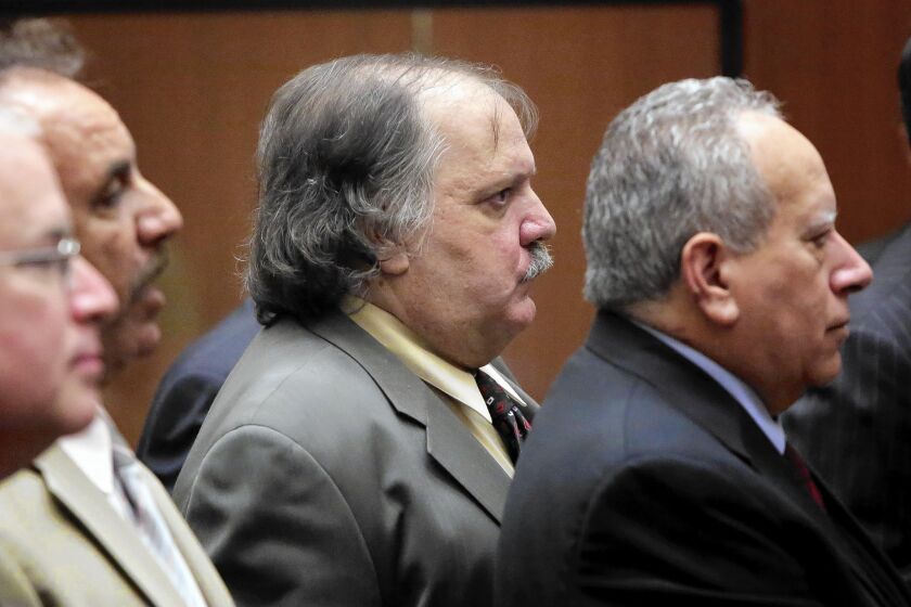Former Bell council member Victor Bello, center, is among five ex-Bell officials who are considering a plea deal.