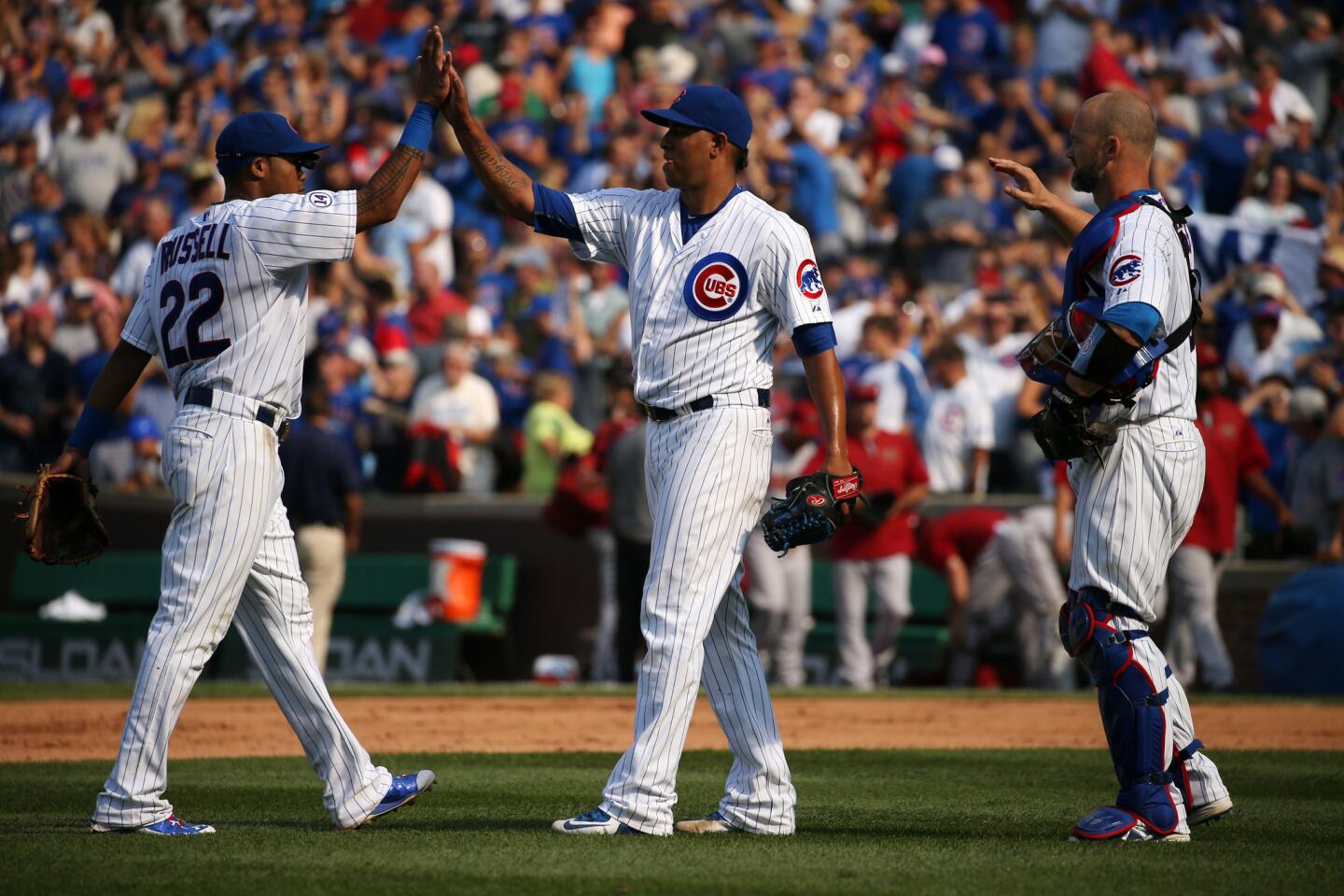 Cubs relief pitcher Hector Rondon, center, is congratulated by second baseman Addison Russell after making the final out.