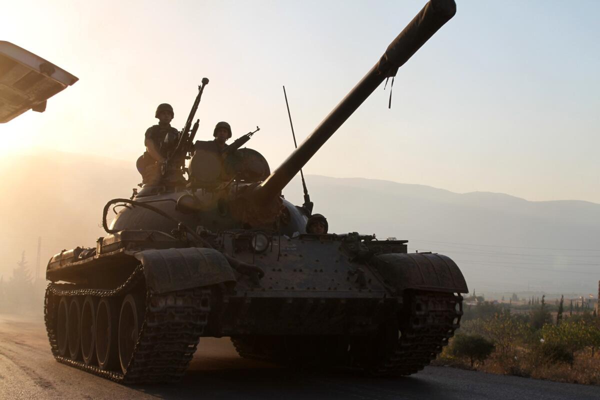 A Lebanese army tank approaches the town of Arsal near the Syrian border to help secure the area where gunmen reportedly killed two soldiers after clashes erupted following the arrest of a Syrian linked to an Islamist militant group.