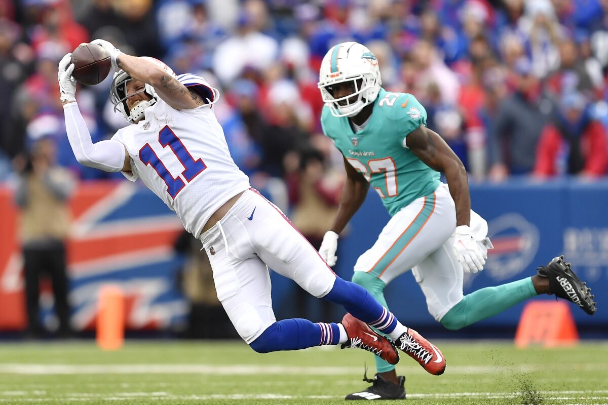 Buffalo Bills wide receiver Cole Beasley (11) hangs onto the ball on a catch against Miami Dolphins cornerback Justin Coleman (27) during the second half of an NFL football game, Sunday, Oct. 31, 2021, in Orchard Park, N.Y. (AP Photo/Adrian Kraus)