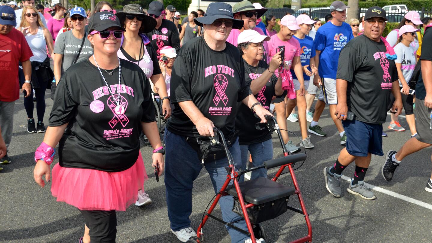Walkers wear custom T-shirts supporting cancer survivors and patients during Sunday's More than Pink 5K presented by Susan G. Komen Orange County in Newport Beach.