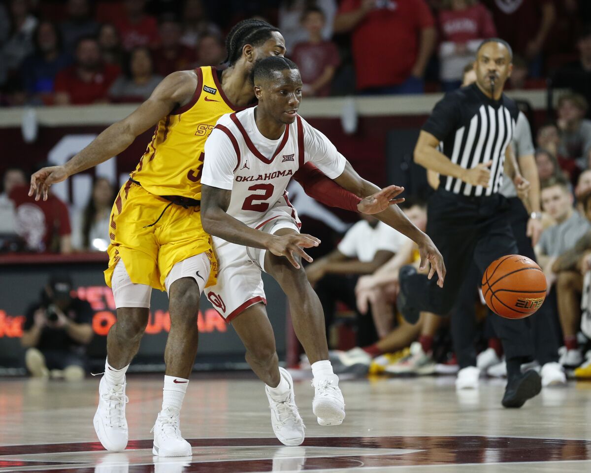Oklahoma guard Umoja Gibson (2) is fouled by Iowa State guard Tre Jackson (3) during the second half of an NCAA college basketball game Saturday, Jan. 8, 2022, in Norman, Okla. (AP Photo/Garett Fisbeck)