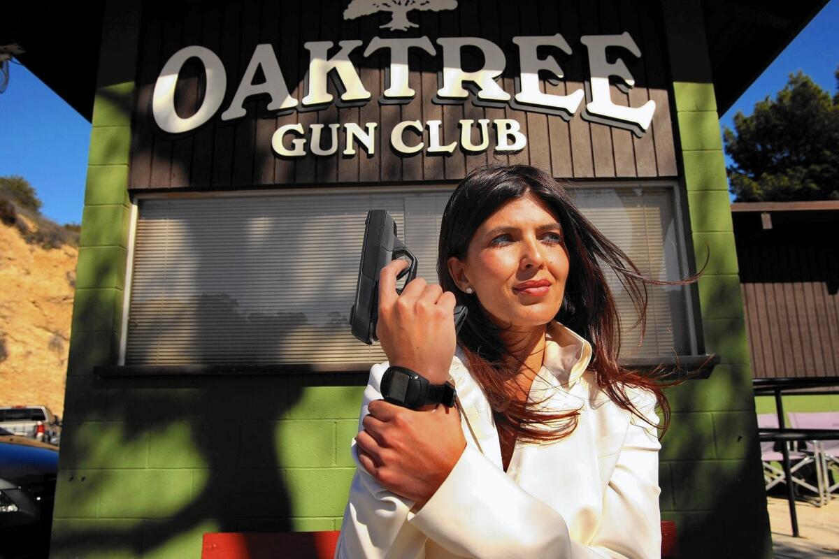 Belinda Padilla, chief executive of Armatix USA Inc., with the Armatix iP1 in 2013. The gun was displayed and demonstrated at the Oak Tree Gun Club in Newhall, Calif., but gun owners lashed out at the club.