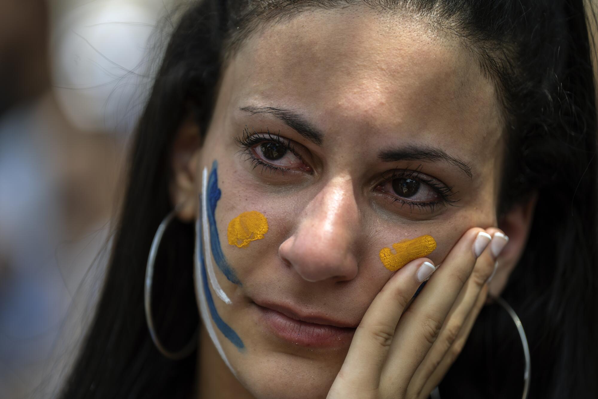 An Uruguay soccer fan reacts at the e 