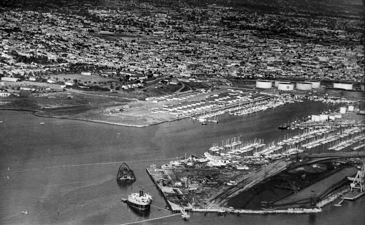 Dec. 18, 1976: Aerial view of San Pedro with the destroyed oil tanker Sansinena at bottom left. Oil storage tanks are on right and Ft. MacArthur on upper left.