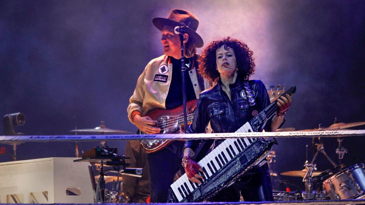 Win Butler and Régine Chassagne of Arcade Fire perform Wednesday at Viejas Arena in San Diego.