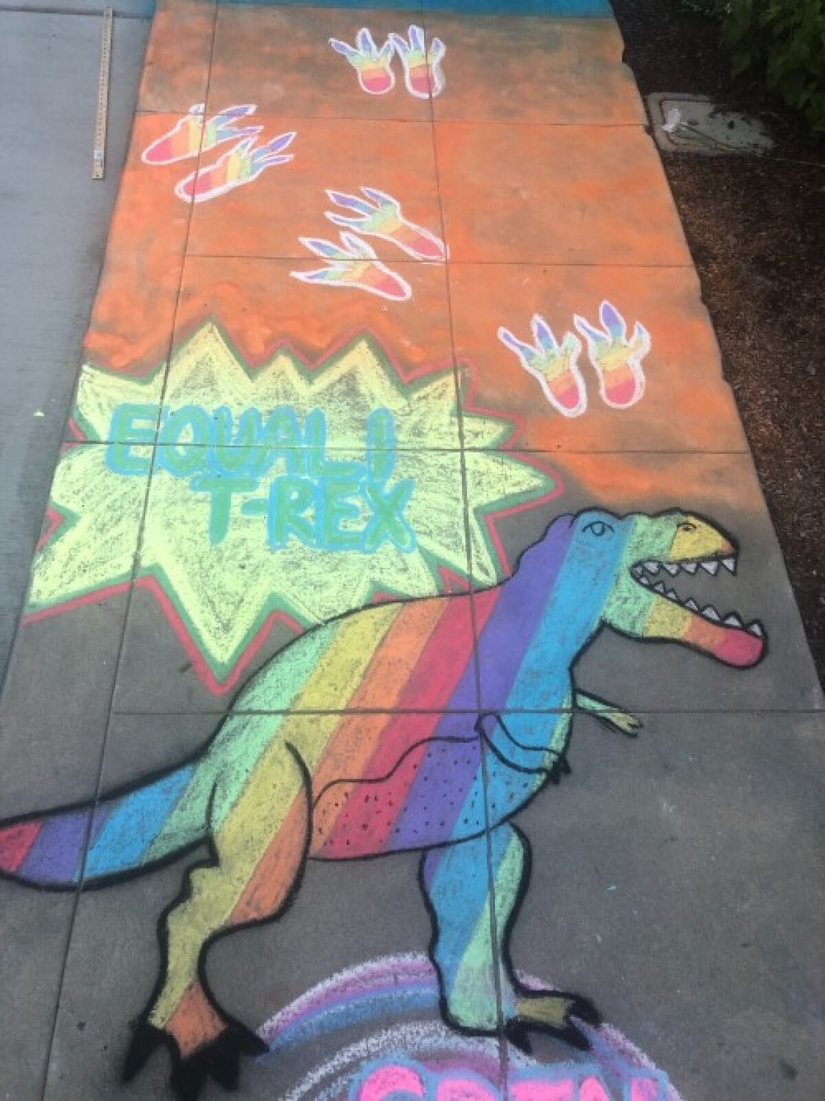 Amelia Leidy's sidewalk chalk projects for June include LGBTQ Pride themes featuring rainbows and this Equali-T-rex.