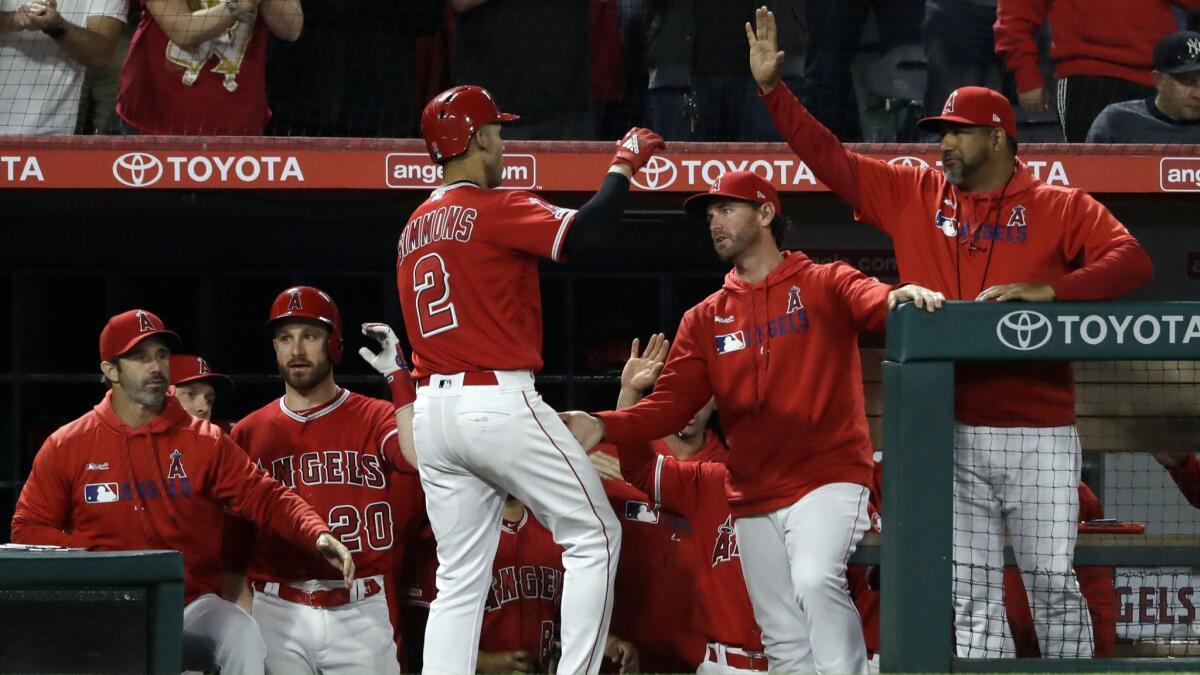 Angels' Andrelton Simmons (2) celebrates his home run with teammates during the fourth inning against the New York Yankees on Wednesday at Angel Stadium.