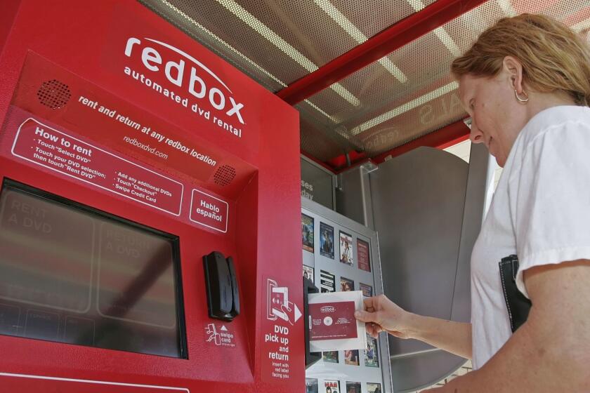 SALT LAKE CITY, UT  APRIL 26: Sandra Burgess returns a DVD movie to a RedBox rental Machine at a McDonald's April 26, 2006 in Provo, Utah. Customers can rent movies for a dollar a night and you can return the movie to any RedBox machine. (Photo by George Frey/Getty Images)