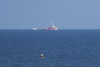 A ship belonging to the Open Arms aid group approaches the shores of Gaza towing a barge with 200 tons of humanitarian aid on Friday, March 15, 2024. The ship set sail Tuesday from Cyprus to inaugurate a sea route to get desperately needed aid into the war-wracked enclave, which is suffering a humanitarian crisis five months into the Israel-Hamas war. (AP Photo/Abdel Kareem Hana)