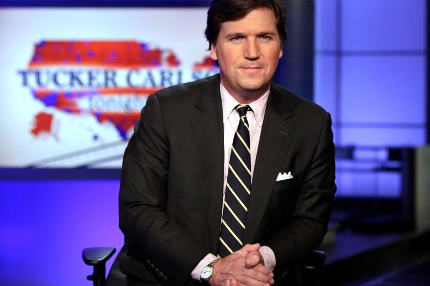 FILE - In this March 2, 2017 file photo, Tucker Carlson, host of "Tucker Carlson Tonight," poses for photos in a Fox News Channel studio, in New York. The Fox News host and longtime conservative commentator has a two-book deal with Threshold Editions, the publisher said Tuesday, May 2. Carlson also authored, âPoliticians, Partisans, and Parasites: My Adventures in Cable News,â which came out in 2003. (AP Photo/Richard Drew, File)