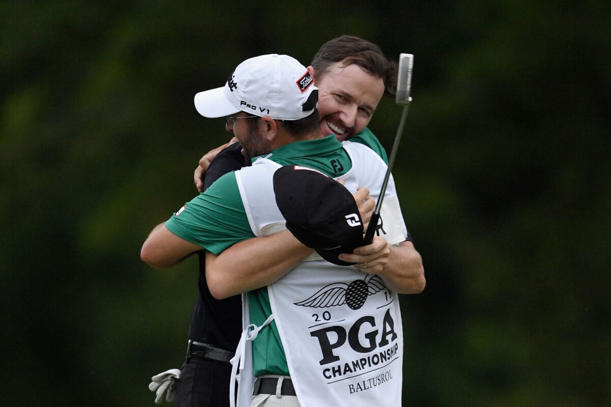 Jimmy Walker hugs caddie Andy Sanders after wrapping up a victory at the PGA Championship.