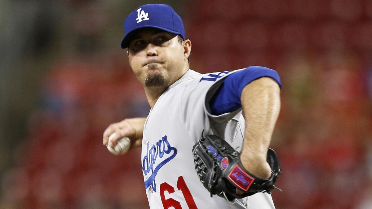 Dodgers starter Josh Beckett delivers a pitch during the first inning of Tuesday's game against the Cincinnati Reds.