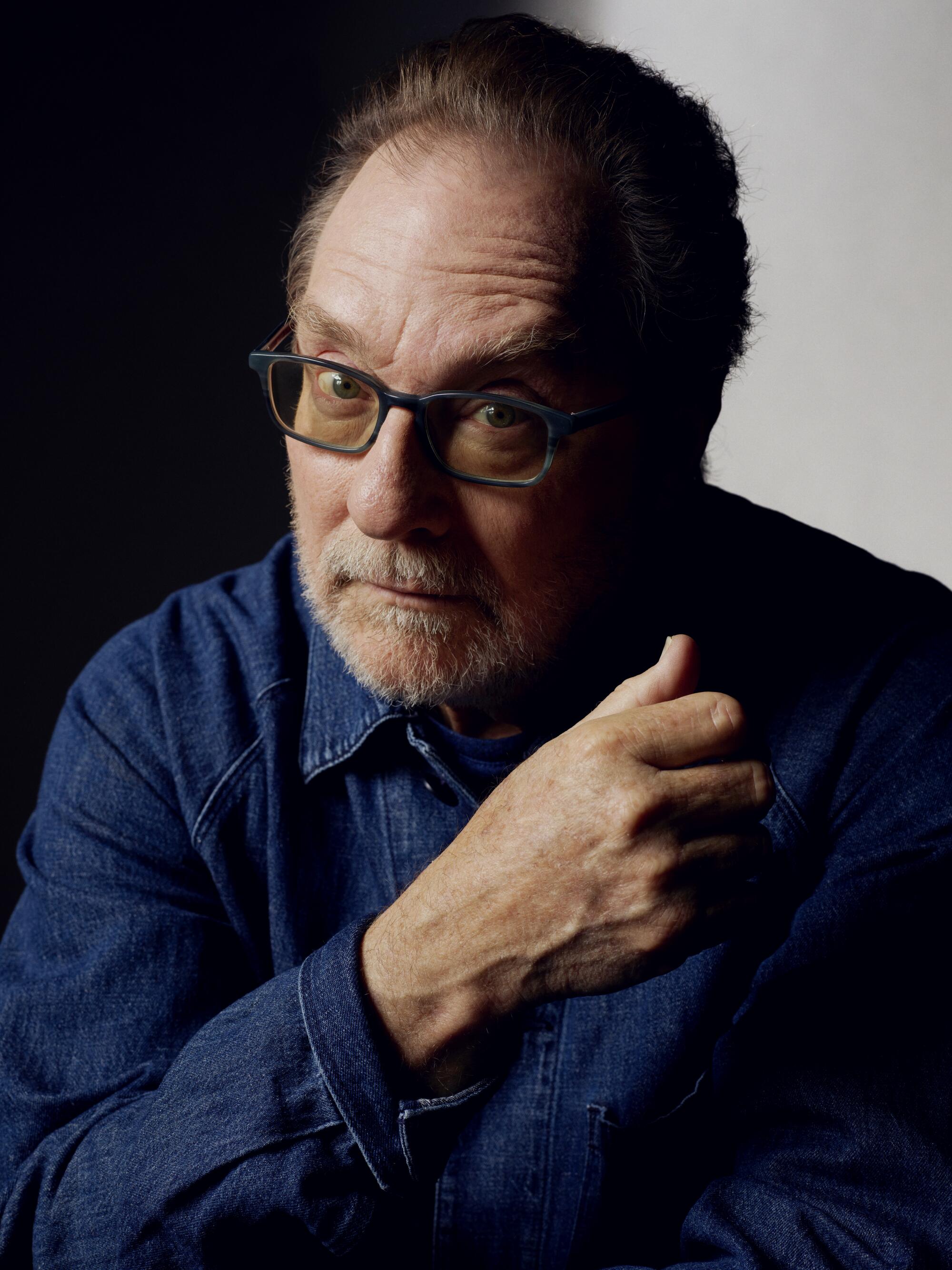 A portrait of Stephen Root wearing glasses