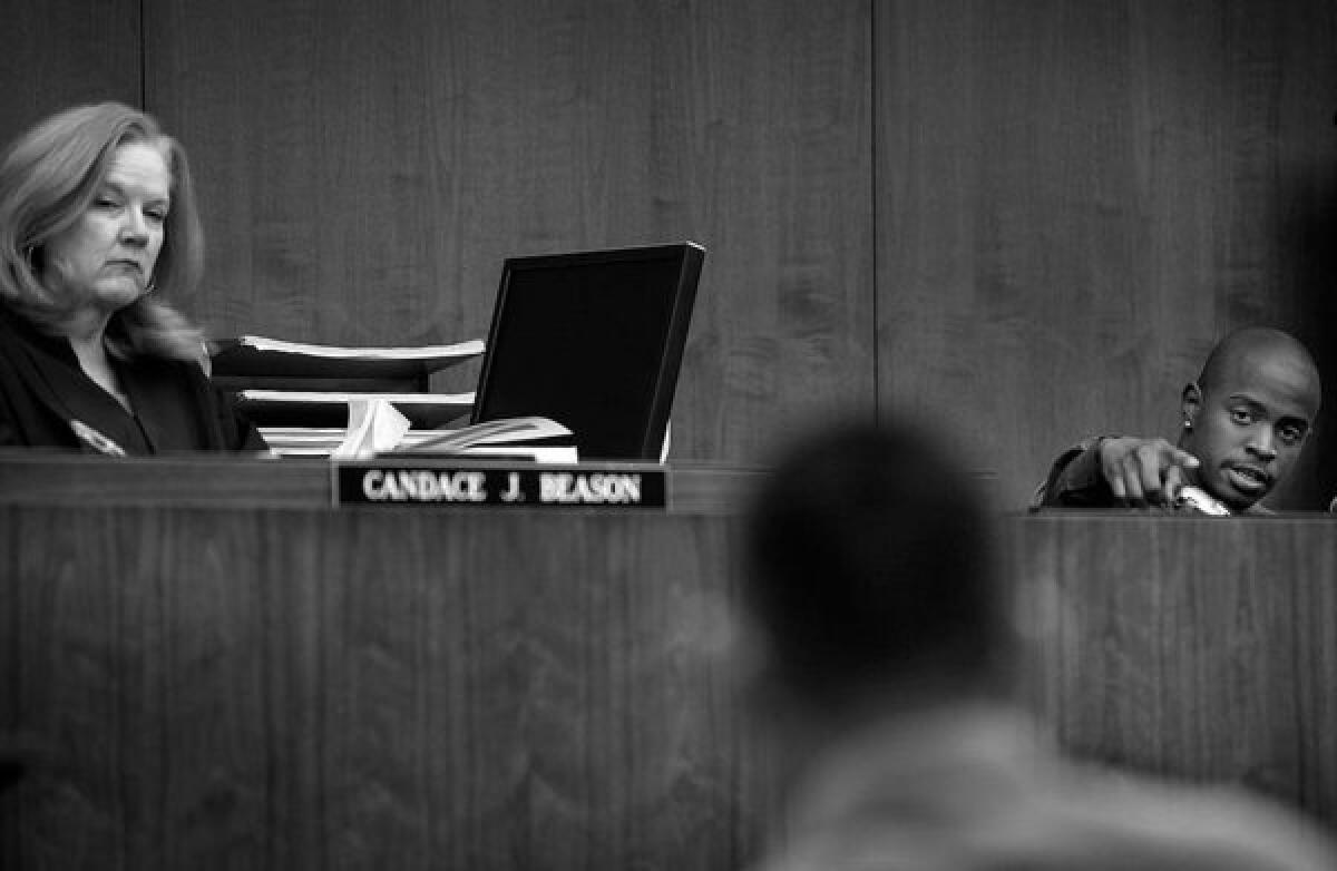 Los Angeles County Superior Court Judge Candace J. Beason looks at Jimmy Santana as Davien points at him and explains to his lawyer that Santana, a former classmate, is the individual who shot him outside Calvary Grace church.