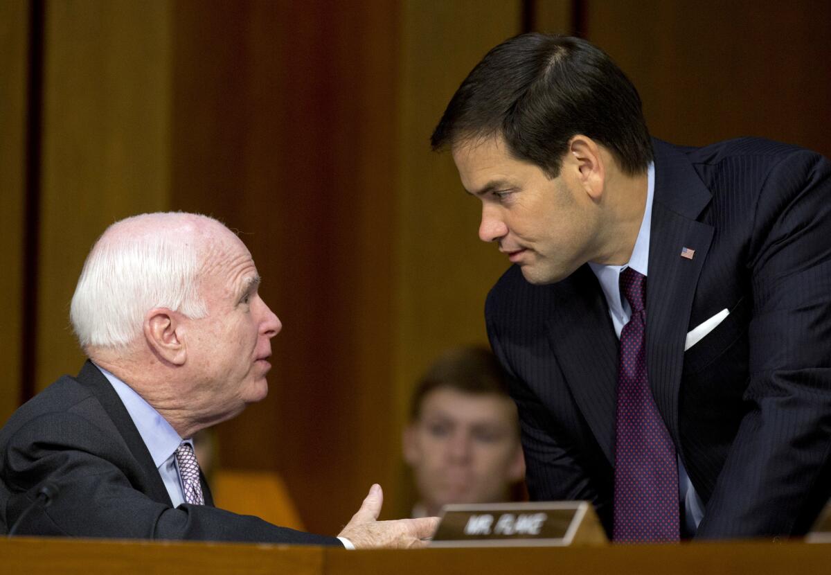 Sen. John McCain, R-Ariz., left, and Sen. Marco Rubio, R-Fla., talk on Capitol Hill in Washington during a Senate Foreign Relations Committee hearing on the U.S. strategy to defeat the Islamic State group.